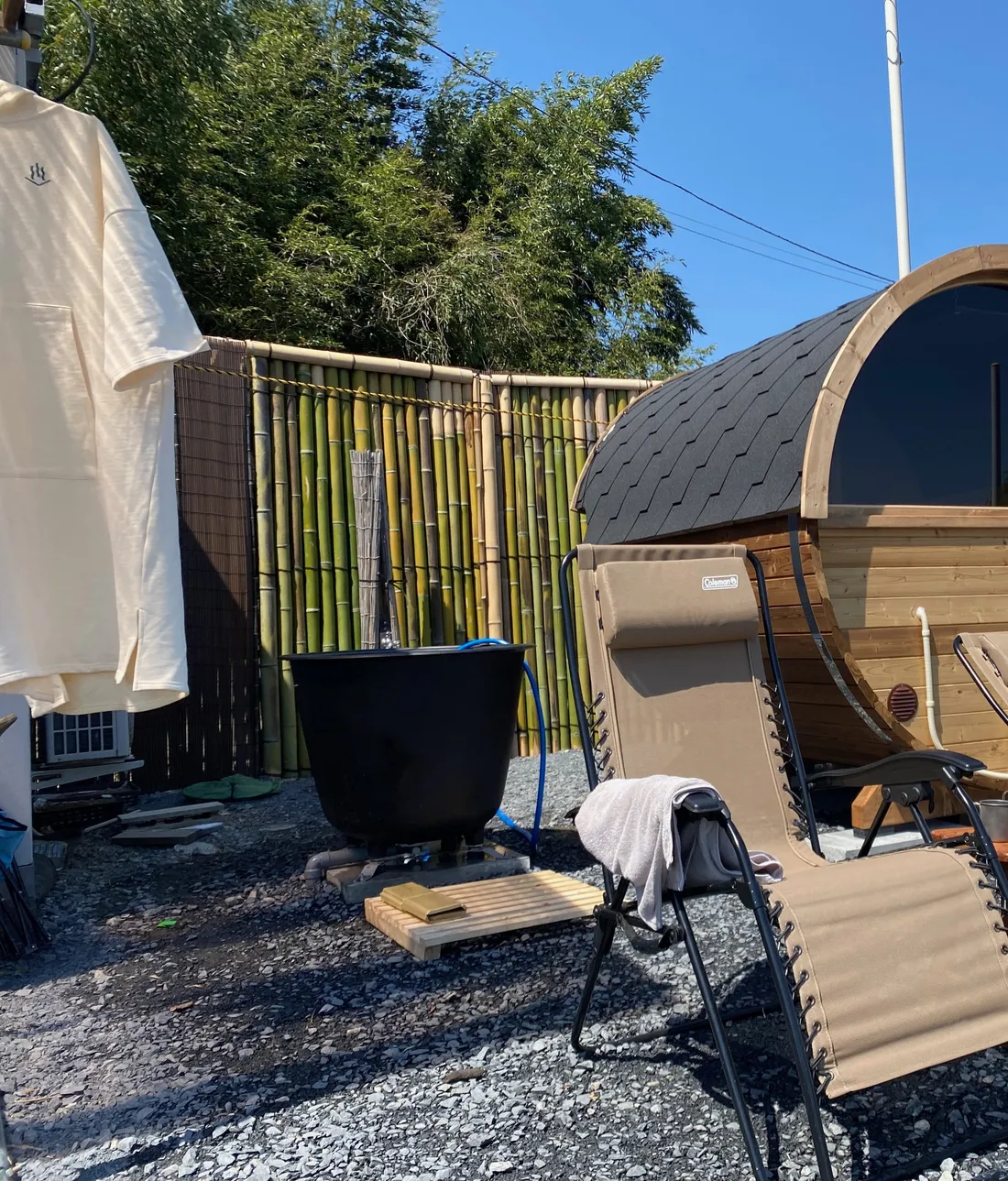 Infinity chairs and the cast-iron cold plunge tub beside the barrel sauna